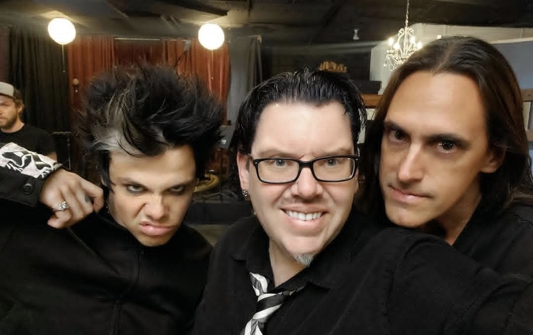 Jack Miele backstage with two rock musicians